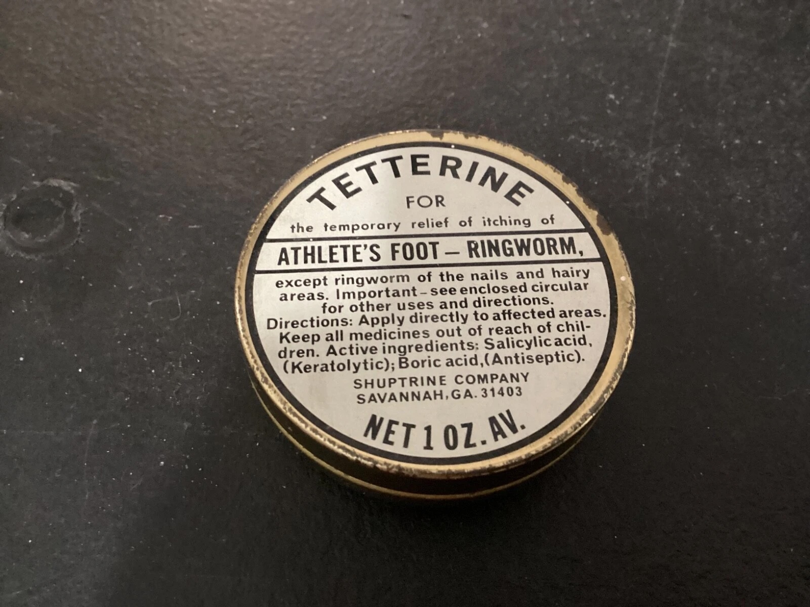 Stamped bottom of a vintage metal tin container
