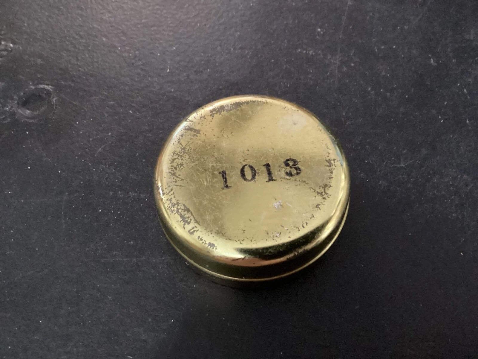 Side profile of a vintage screw-top metal tin