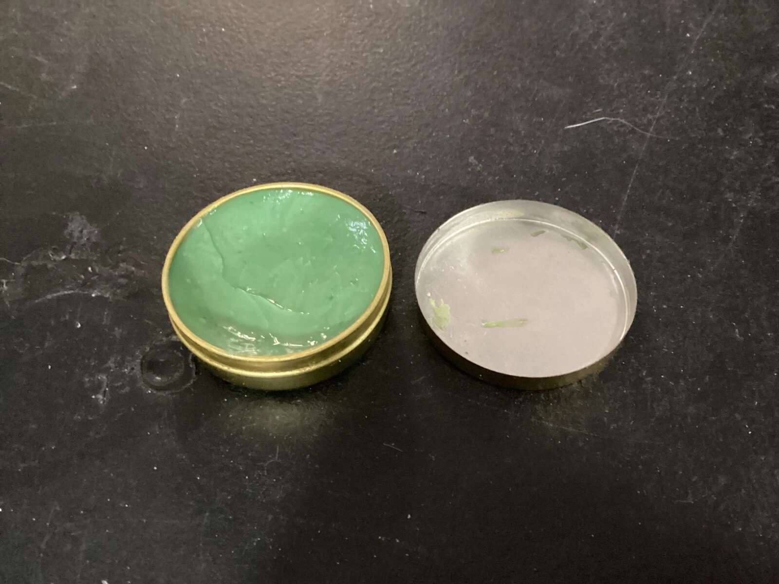 Open tin and lid showing historic ointment presentation