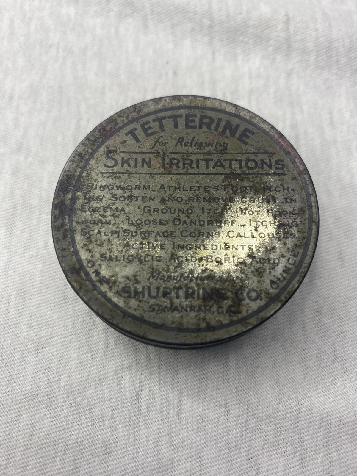 Historic metal tin of a skin ointment labeled for relieving skin irritation